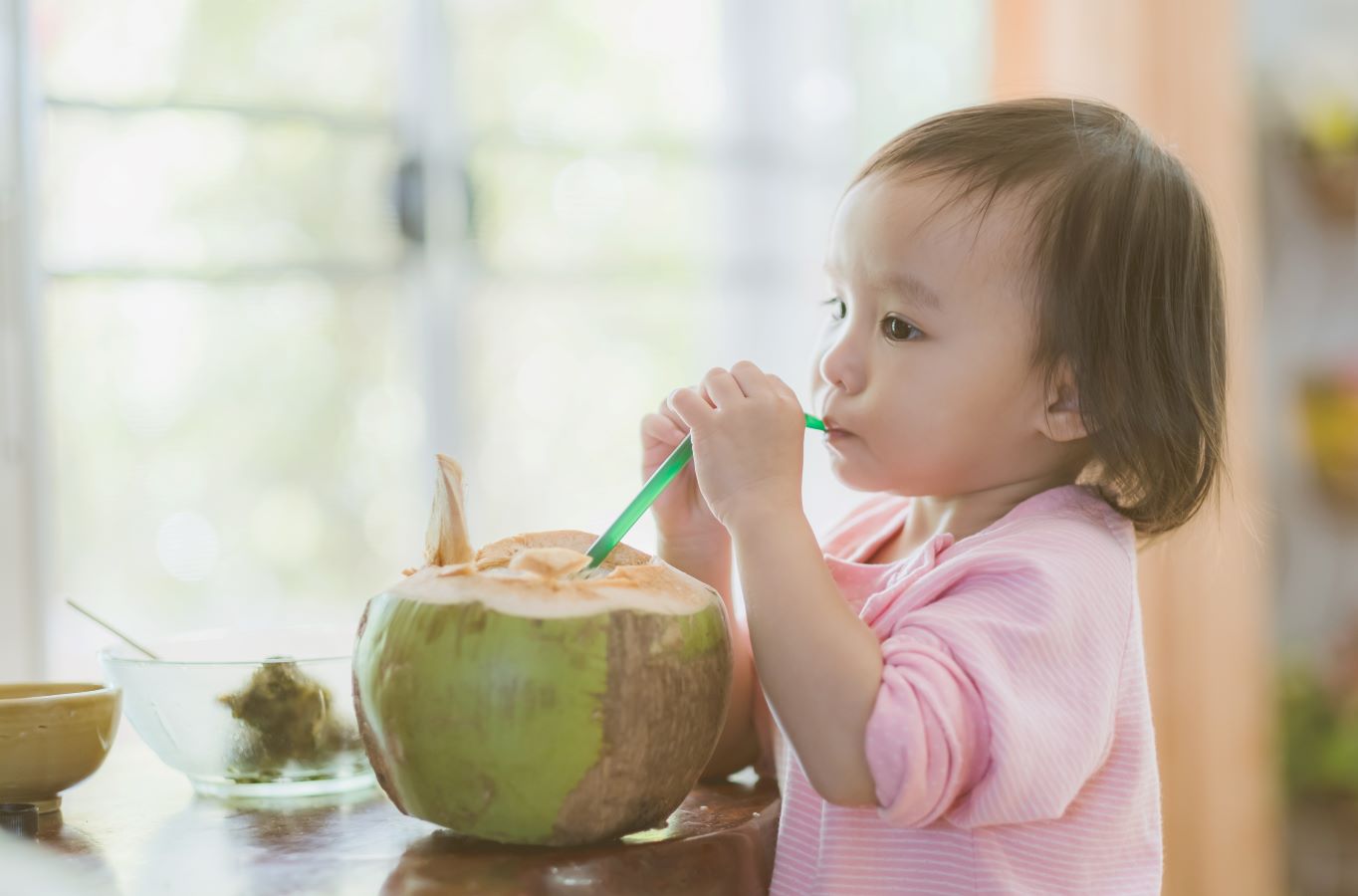 Child drinking from a coconut