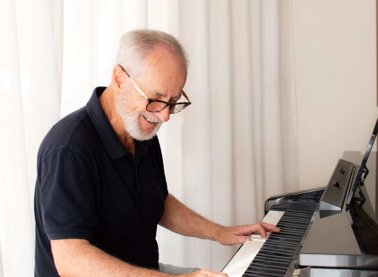 Man learning to play piano