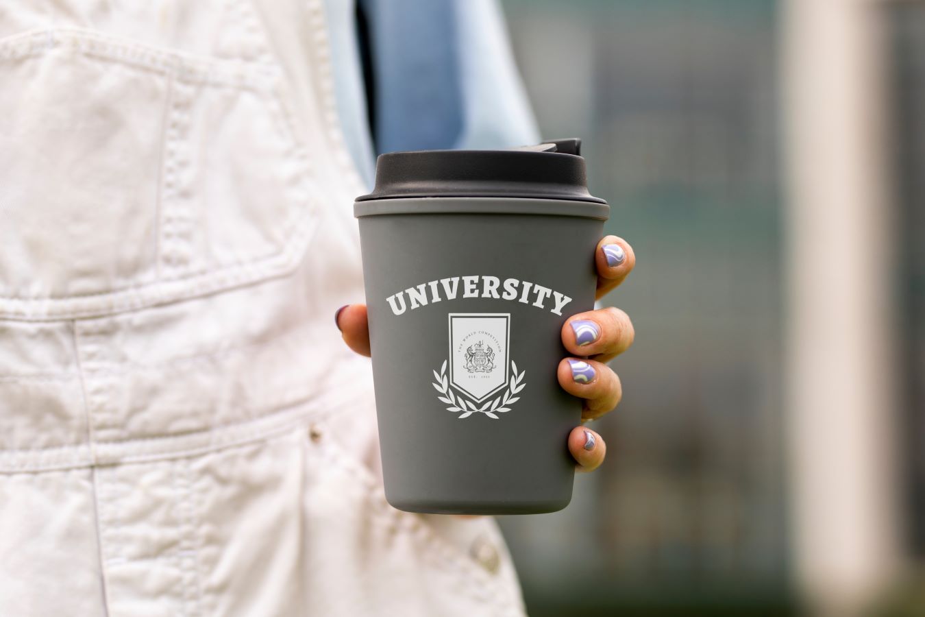 Woman holding a cup that says University