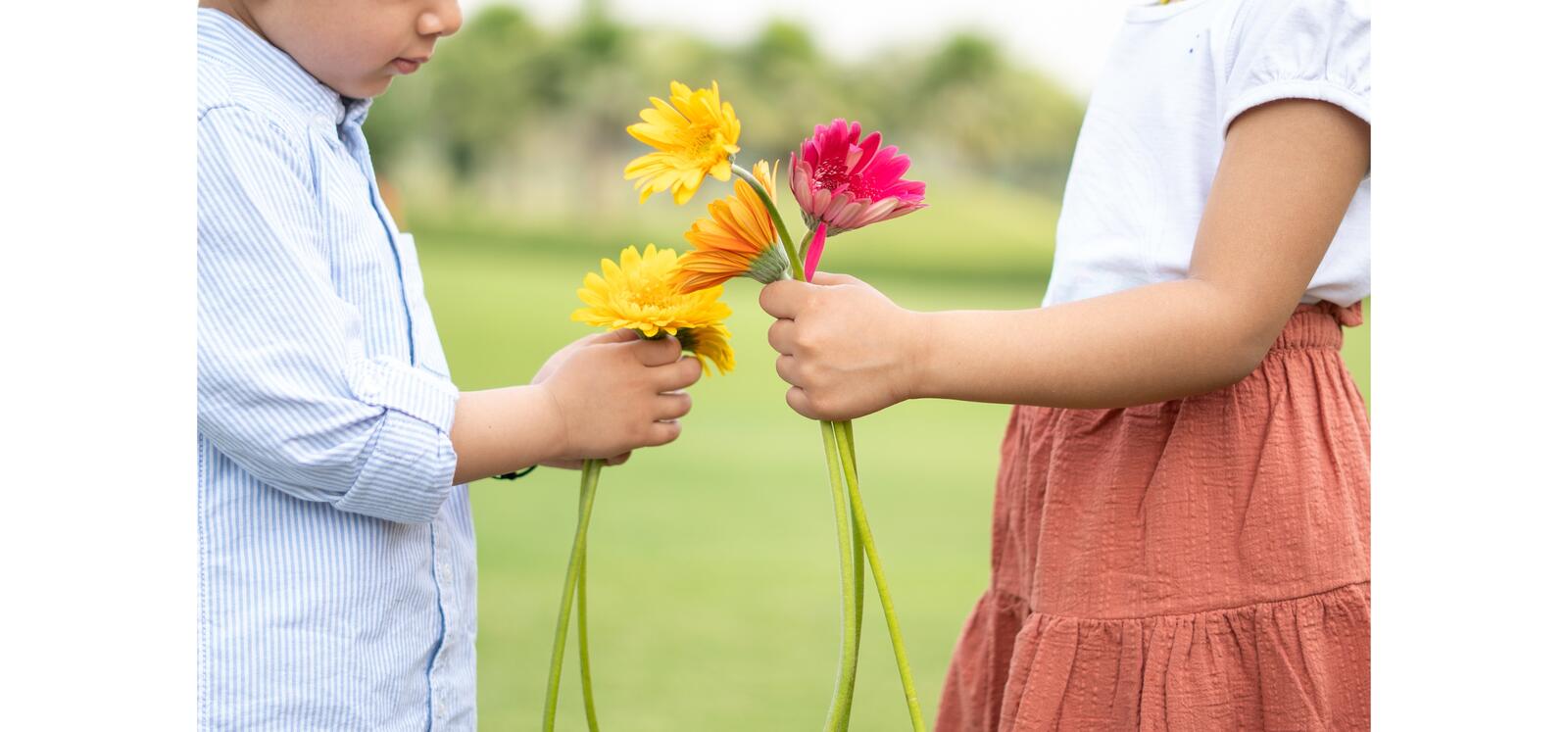 Two kids holding flowers