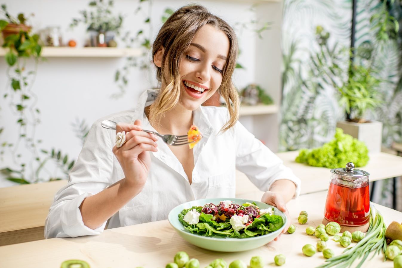 Smiling woman sitting down to eat