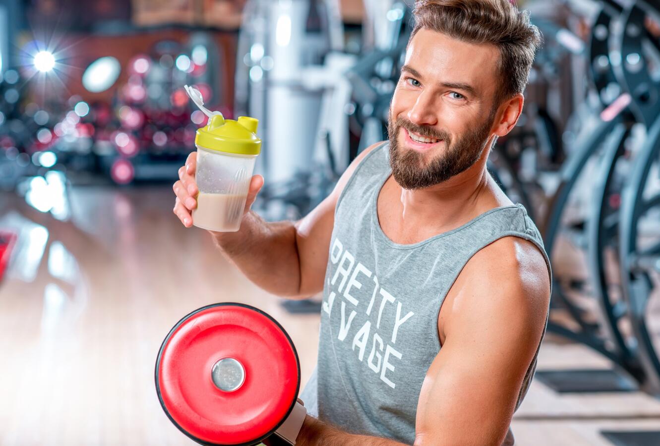 man exercising drinking protein shake