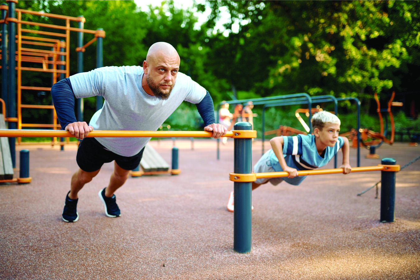 A man exercising together with his son