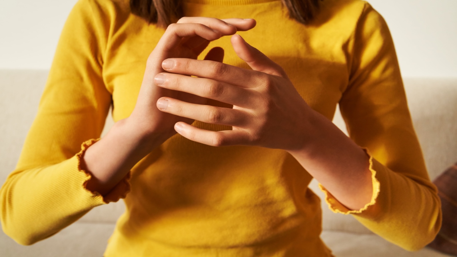 Woman practicing EFT tapping technique using her hands