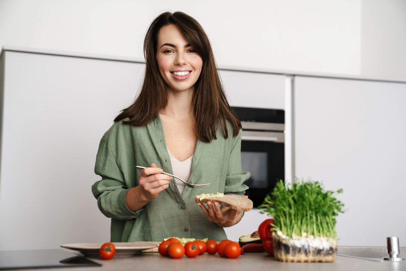 Woman in her kitchen with microgreens