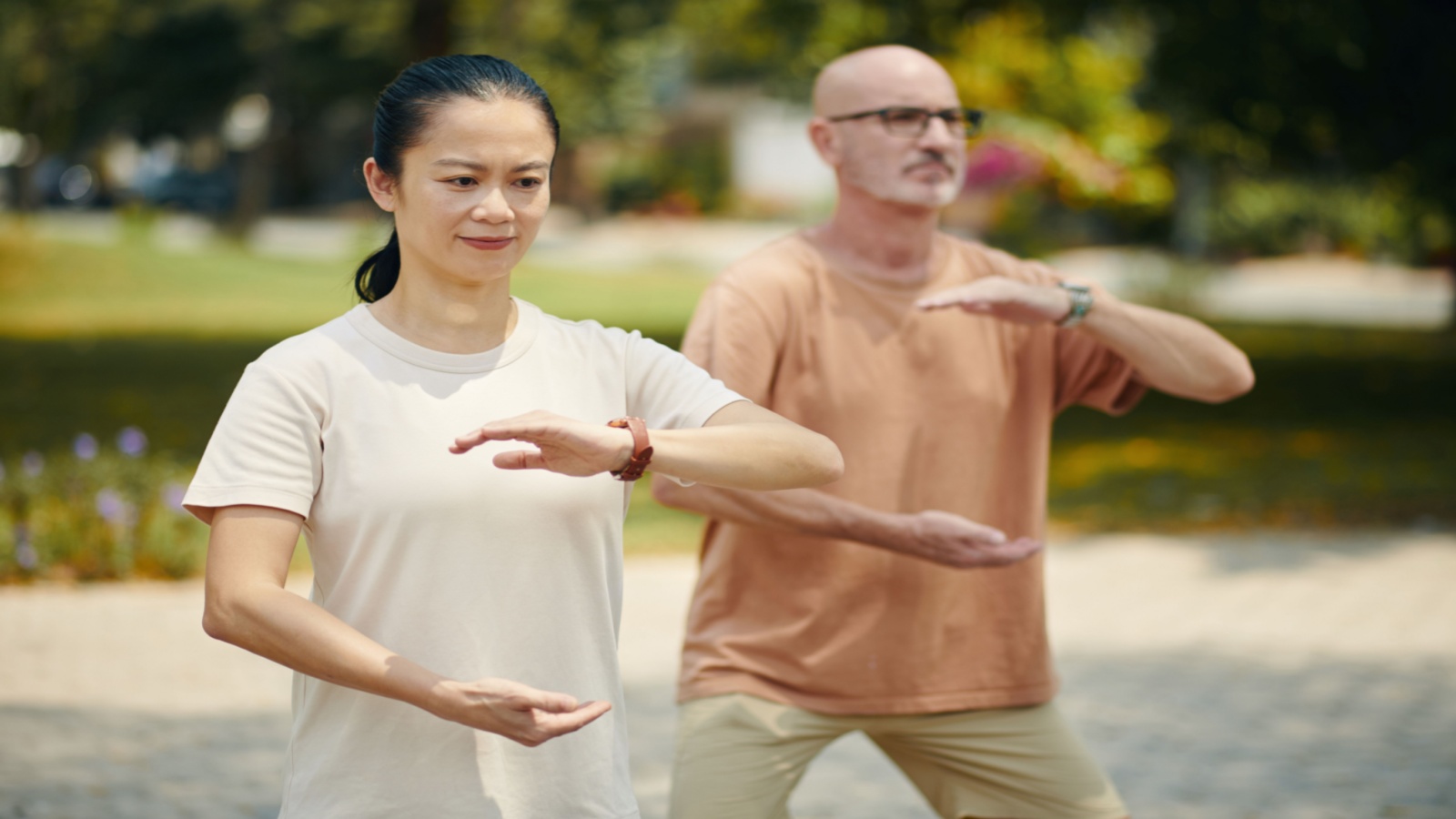 mature woman and man practicing tai chi