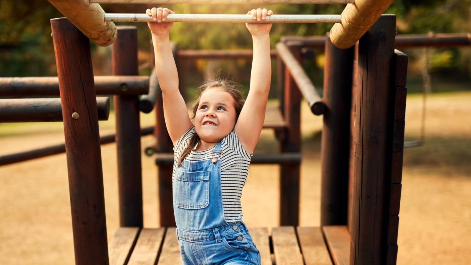 Girl, hanging the monkey bars 