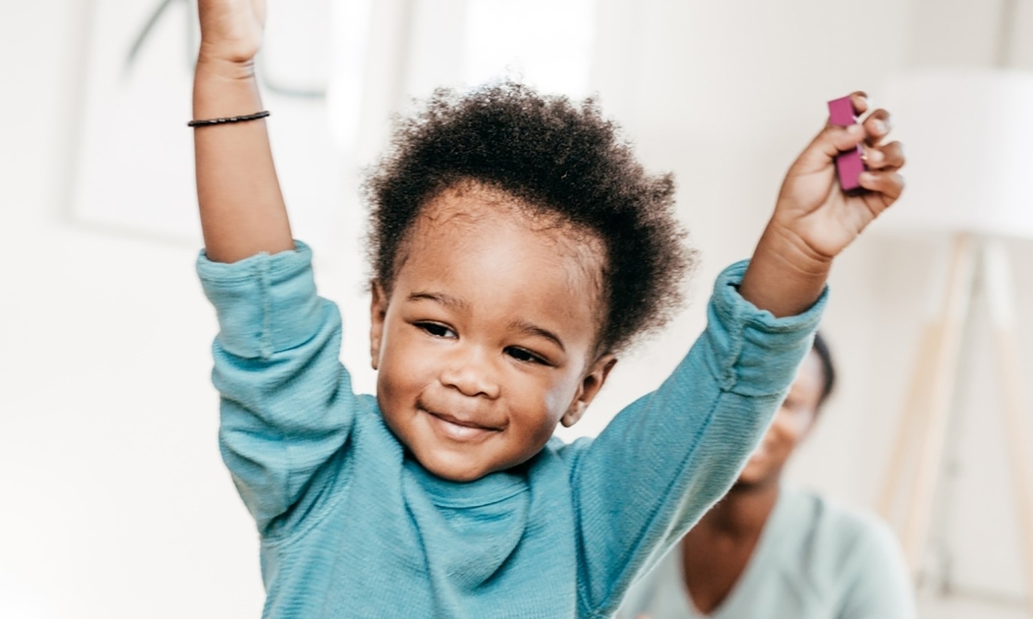 Toddler with his hands in the air
