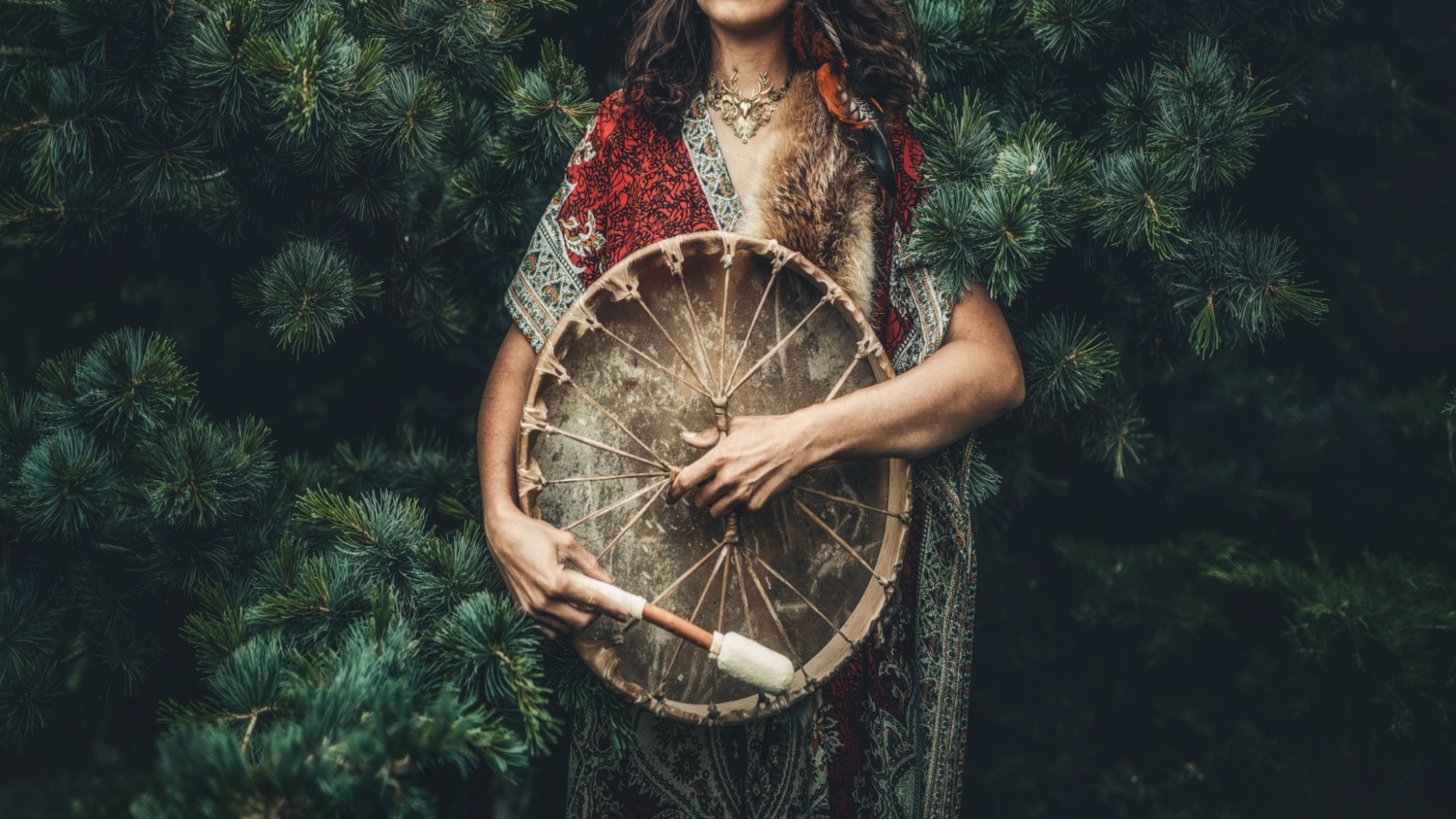 shamanic practitioner holding traditional hand drum