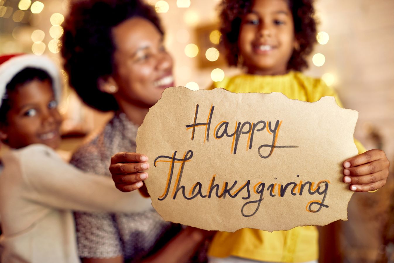 Girl holding a Happy Thanksgiving sign