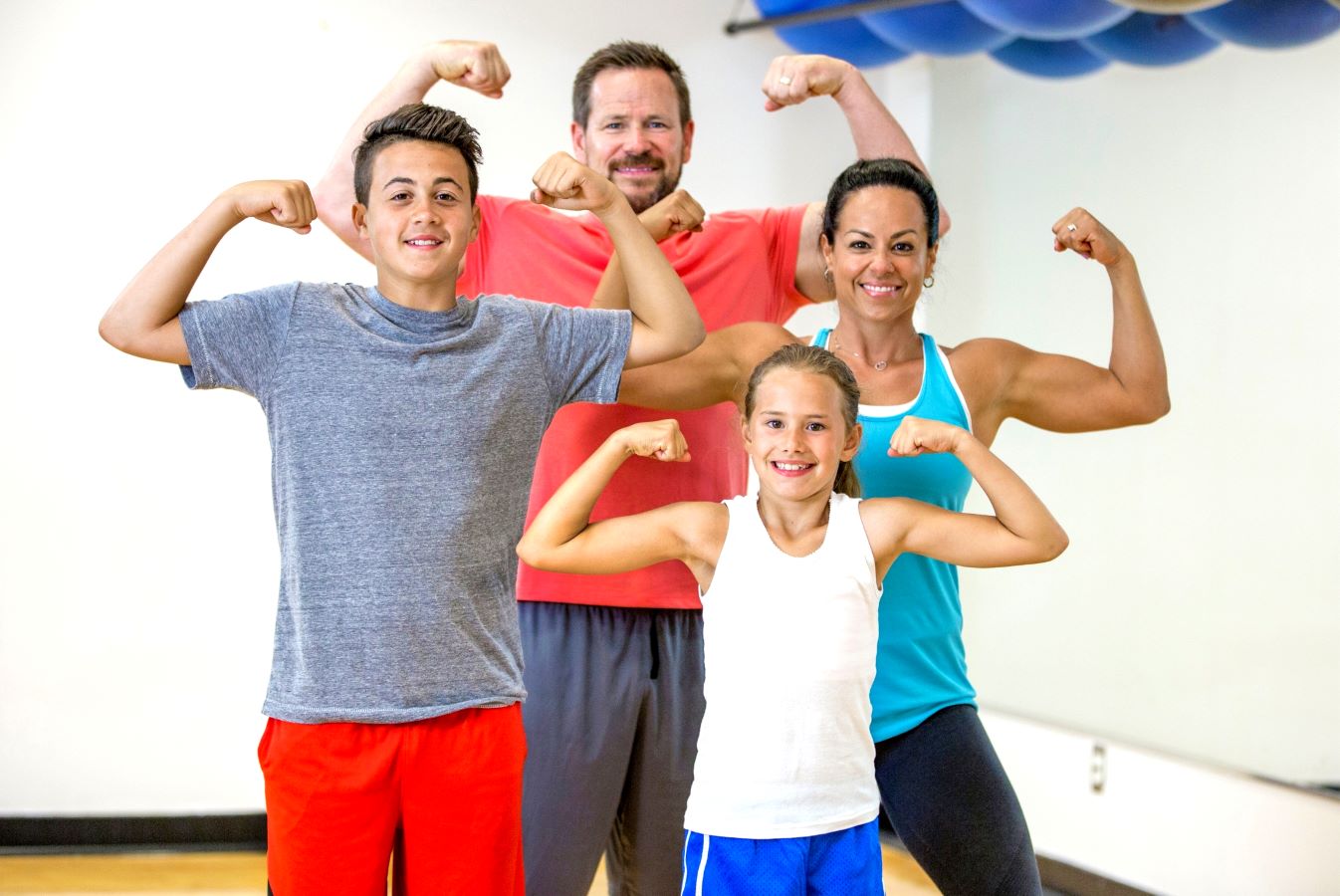 A family flexing their muscles