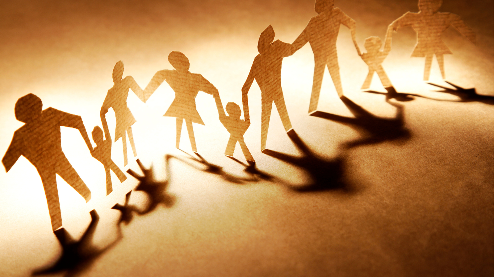 paper cut-outs of family members holding hands, forming a family constellation