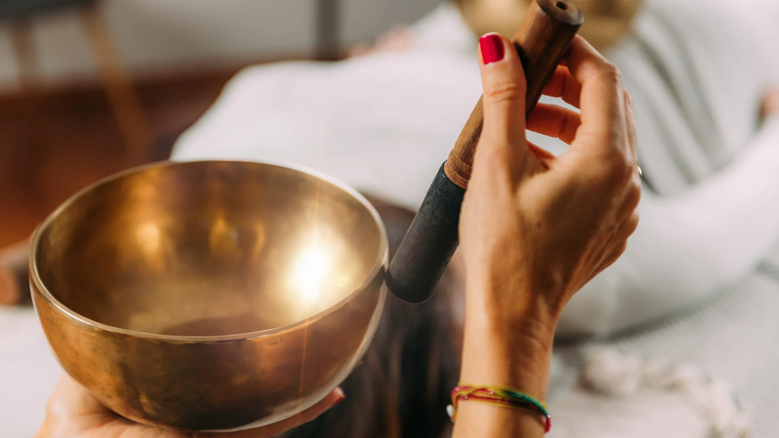 singing bowls being played over patient