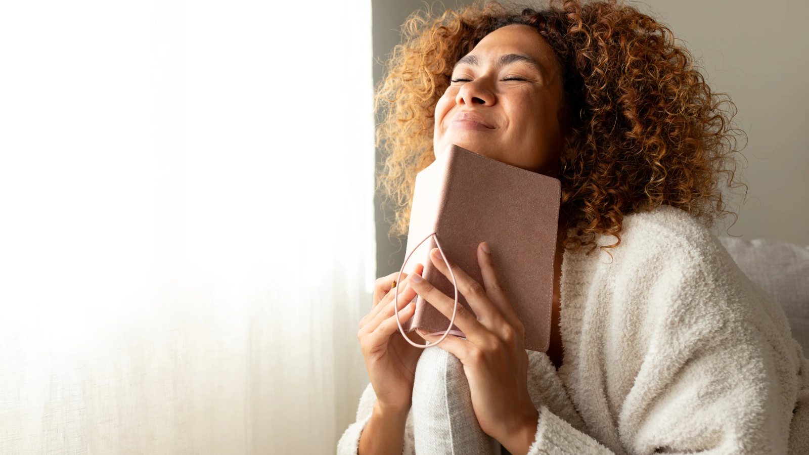 Woman manifesting in her journal