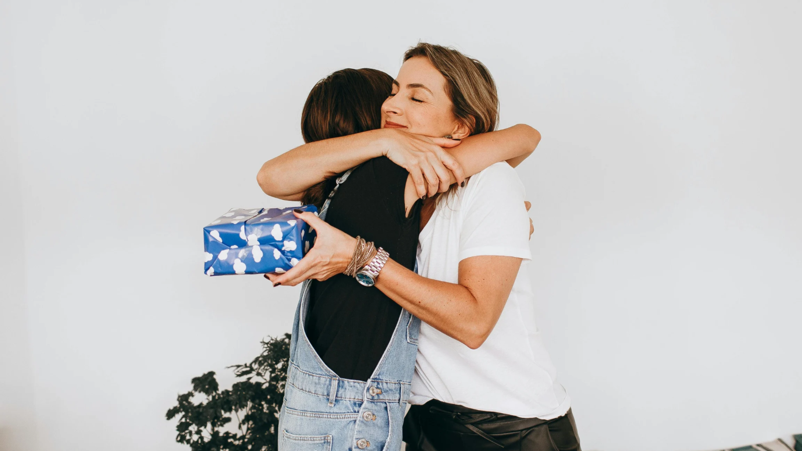 two women hugging, gratitude after receiving a gift
