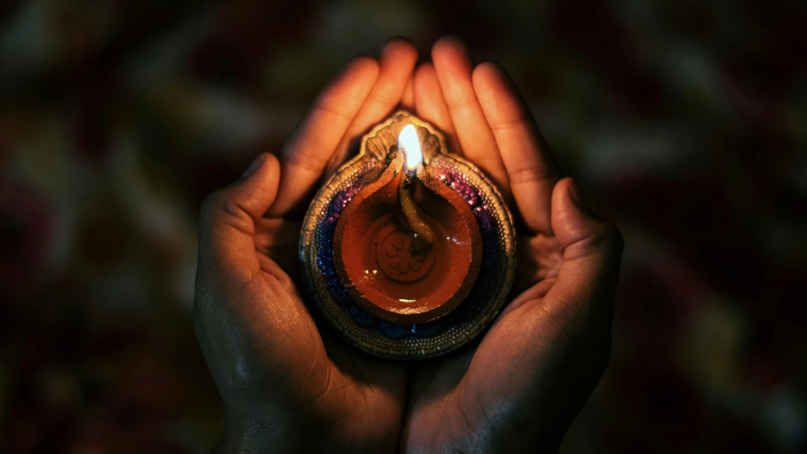 Cupped hands holding a candle for ritual