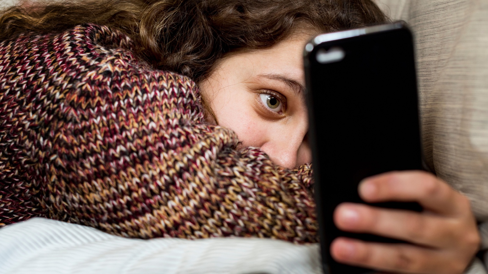 girl scrolling on her phone