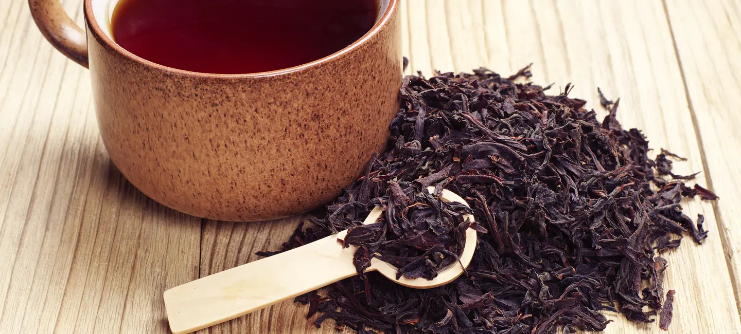 Black Tea in a cup and dried leaves