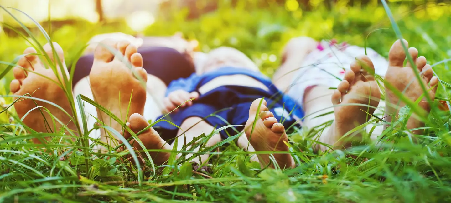feet of a family in the grass
