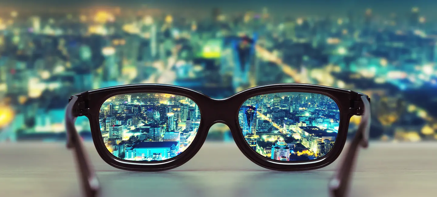 Night cityscape focused in glasses lenses