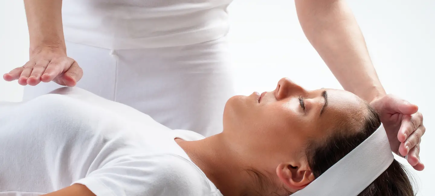 woman receiving Healing Touch treatment
