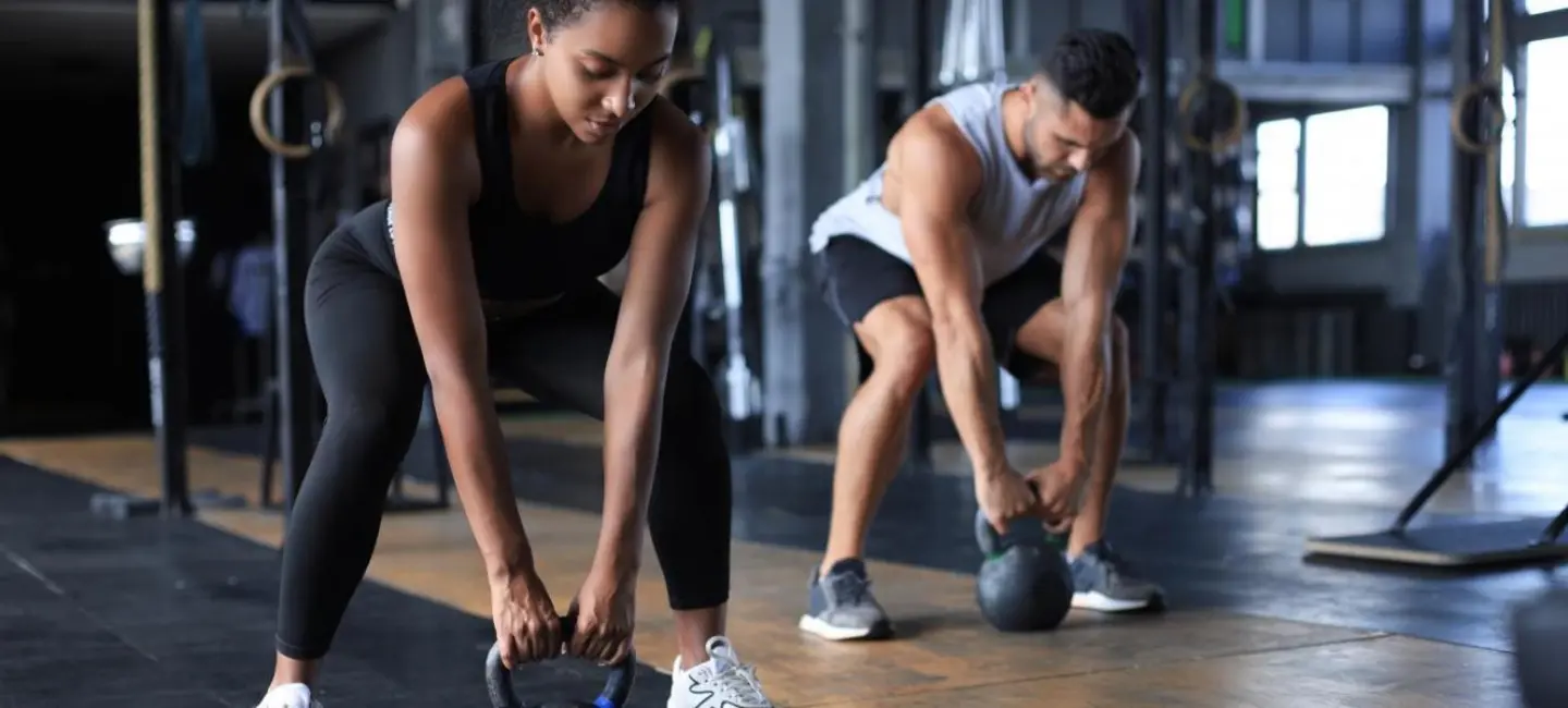 couple lifting a dumbbell for Muscle Training
