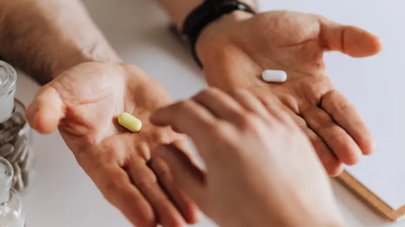 hands with vitamins and medicine