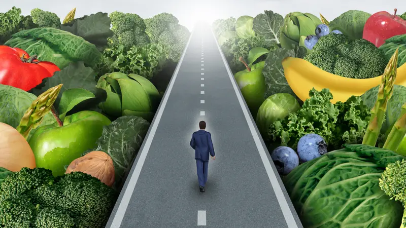 man on road past fruits and veggies