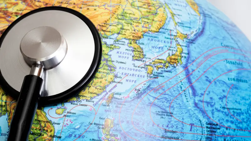 Stethoscope on a globe, people and planet health connection Stethoscope on a globe, people and planet health connection