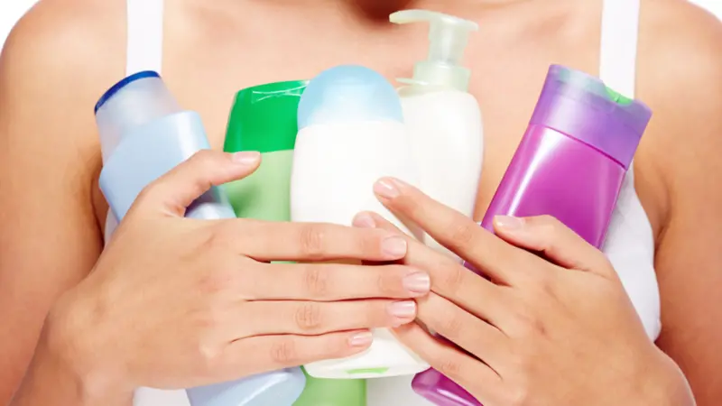 Woman with bottles of different hygiene products