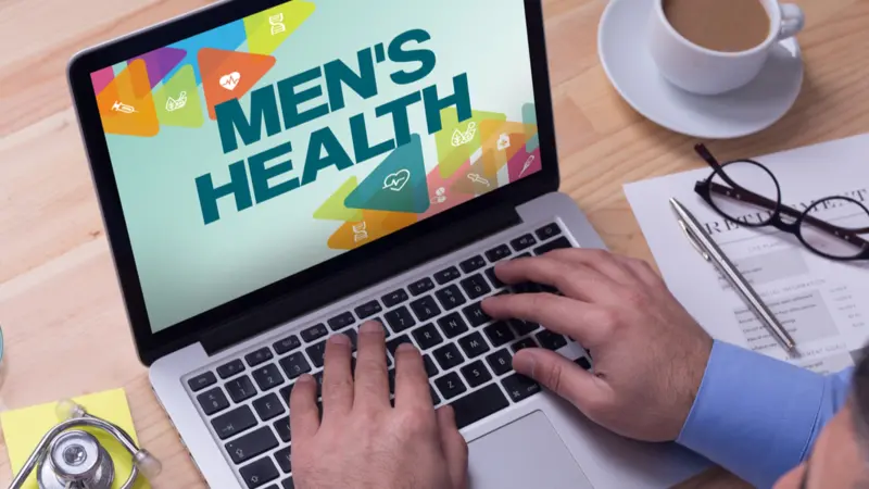 Doctor working on a laptop and MEN'S HEALTH on his screen Doctor working on a laptop and MEN'S HEALTH on his screen