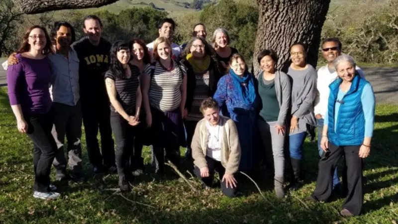 IM4US Team of People Standing Under A Large Tree