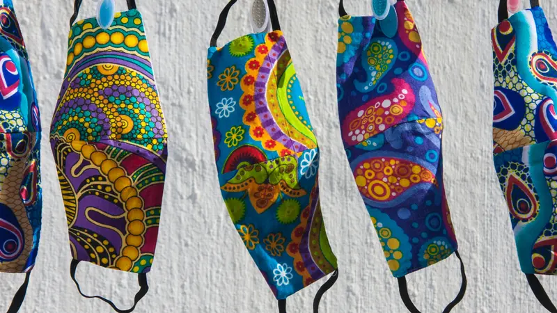 Colorful South African fabric face masks for Covid-19 protection hanging out to dry on a clothesline Colorful South African fabric face masks for Covid-19 protection hanging out to dry on a clothesline