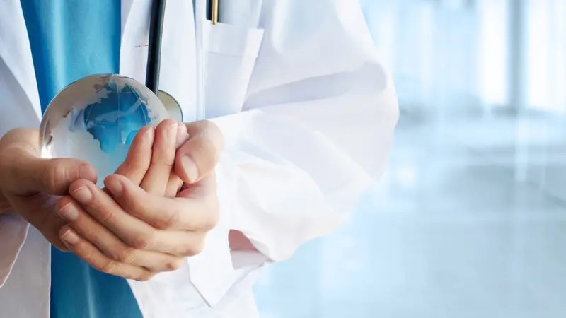 Doctor hand holding a symbolic globe