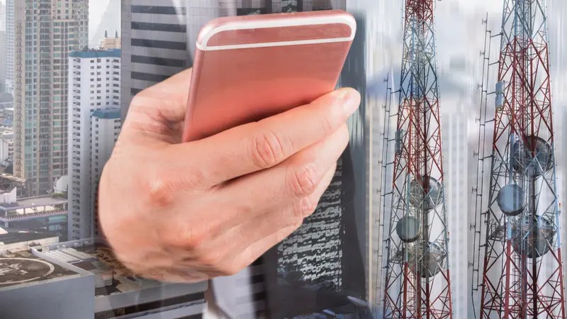 Double exposure of businessman use smartphone, communication tower or 4G 5G network