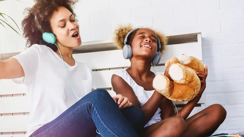 Girls having fun at home, listening music
