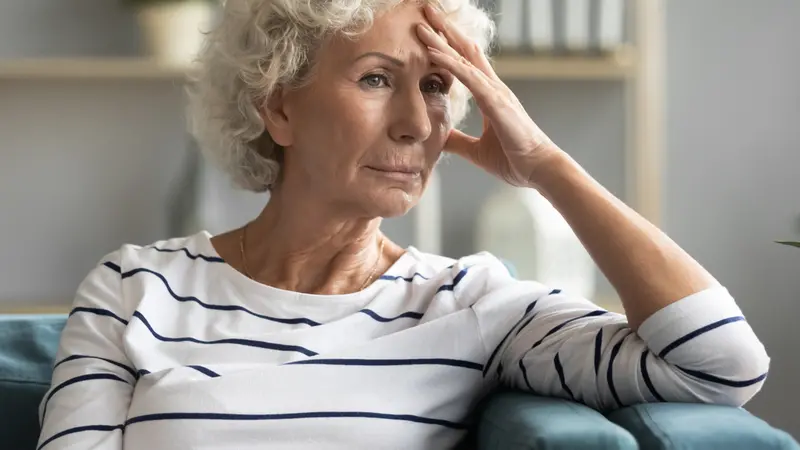 woman sitting on couch thinking