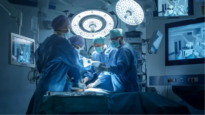 Medical Team Performing Surgical Operation in Modern Operating Room Medical Team Performing Surgical Operation in Modern Operating Room