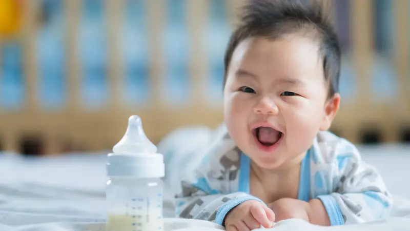 baby smile with milk bottle