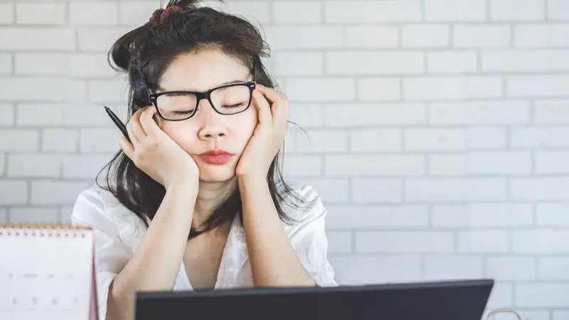 woman sleepy taking a nap at desk woman sleepy taking a nap at desk