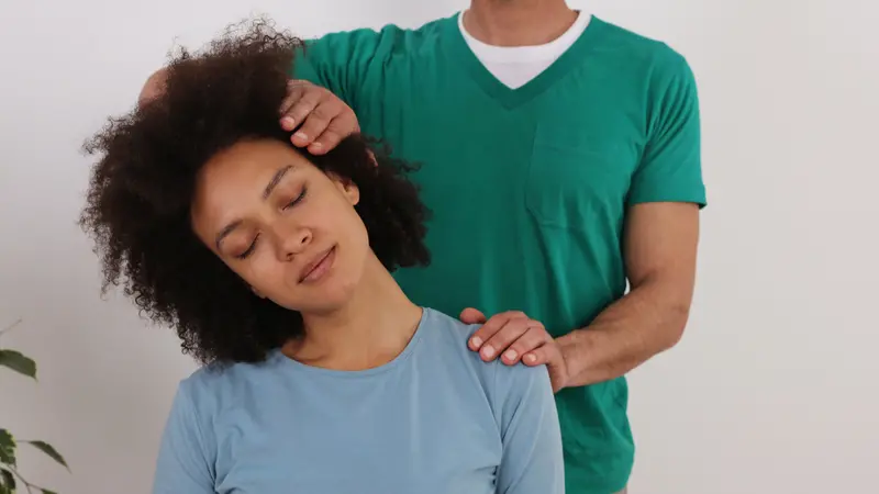 Woman having chiropractic back adjustment in rehabilitation clinic Woman having chiropractic back adjustment in rehabilitation clinic
