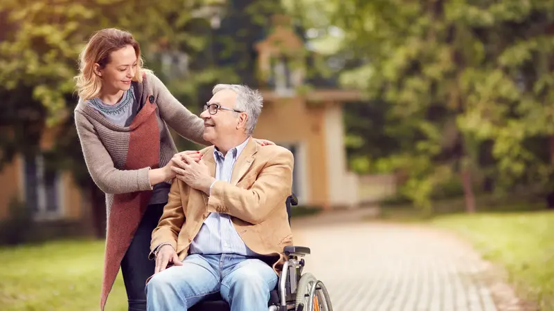 man in wheelchair with happy caregiver man in wheelchair with happy caregiver