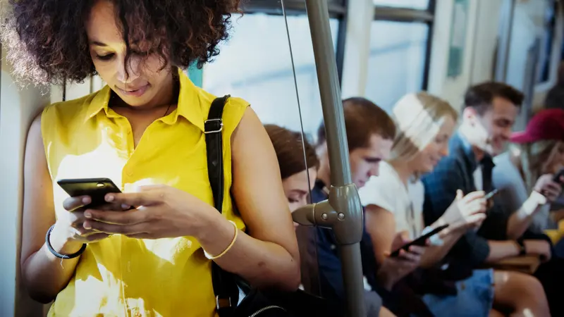 Young woman using a smartphone in a subway