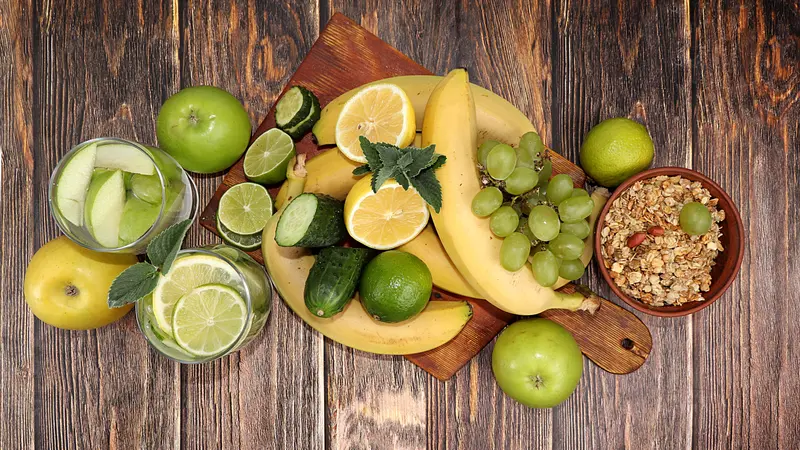 Vegetables, fruits, juice and granola on a dark background. 