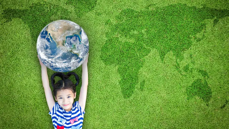 environment concept with kid raising world on lawn environment concept with kid raising world on lawn