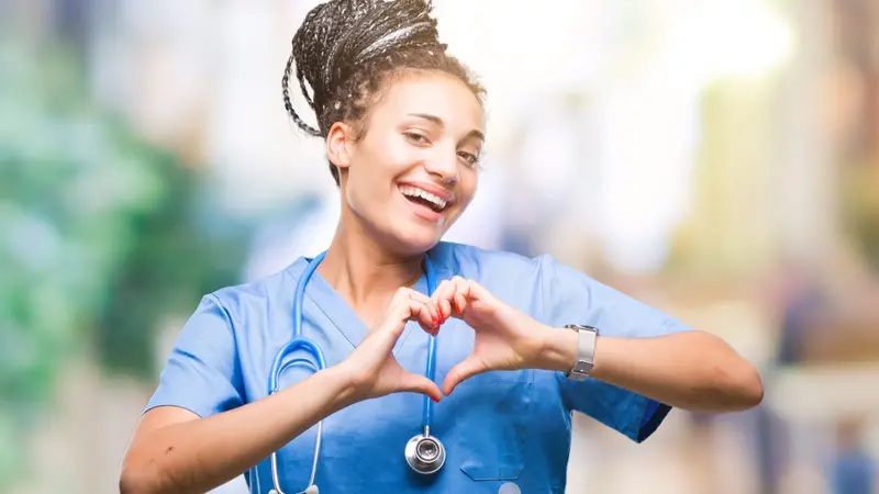 nurse showing heart symbol and shape with hands