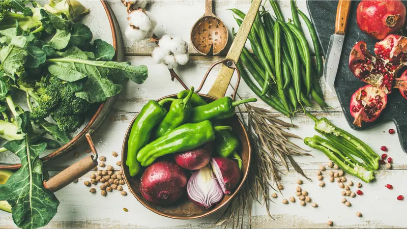 Flat-lay of vegetables, fruit, beans, cereals, kitchen utensil, dried flowers, olive oil over white wooden background, top view. Flat-lay of vegetables, fruit, beans, cereals, kitchen utensil, dried flowers, olive oil over white wooden background, top view.