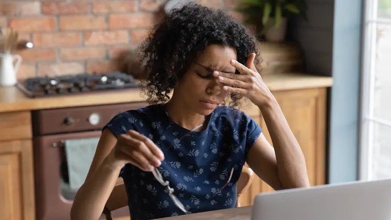 woman work on laptop at home office struggle with migraine or headache