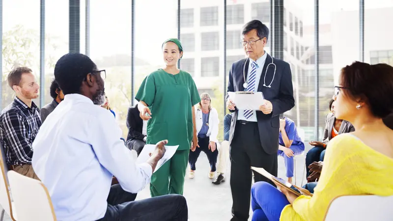 Diverse People Listening to the Doctor's Presentation