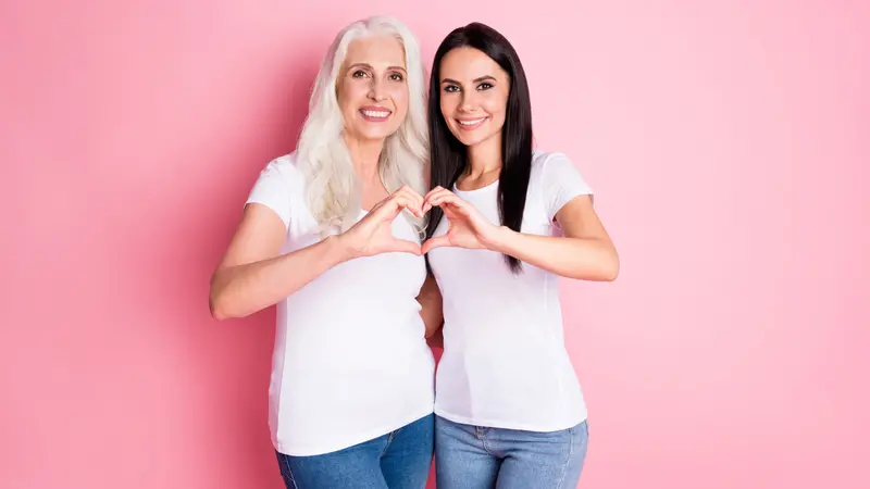 aged mother young daughter hugging showing fingers heart figure symbolizing cardiac health 